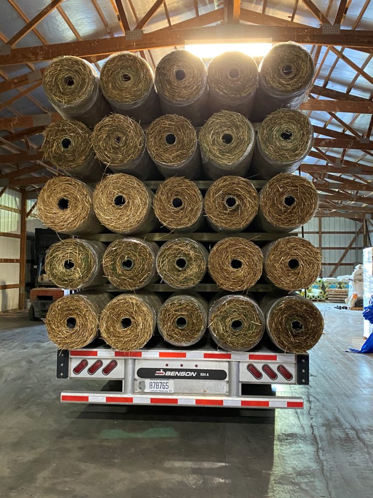 Flatbed trailer loaded with straw mats